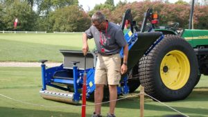 Turf tractor student on golf green