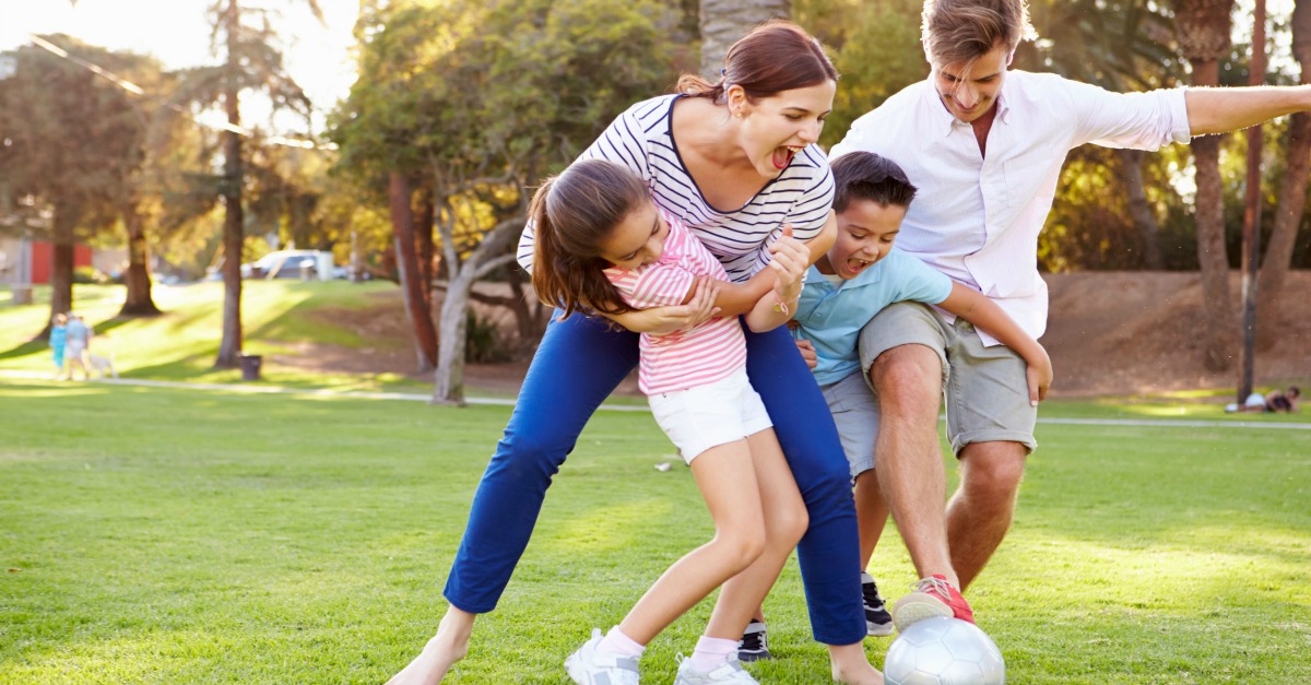 Family playing soccer