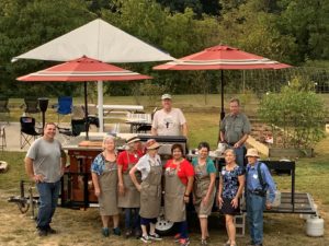 volunteers at an outdoor cooking demonstration