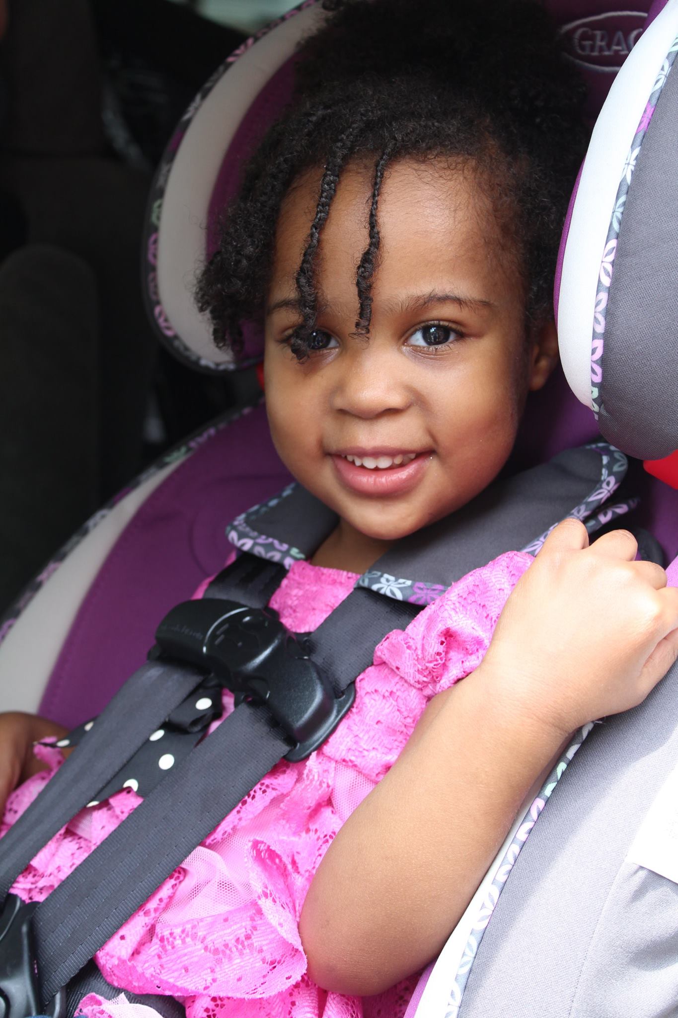 Young girl in a car seat installed correctly