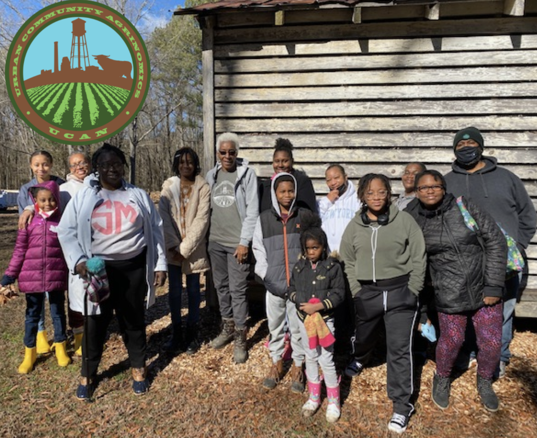 A group of children and volunteers pose together.